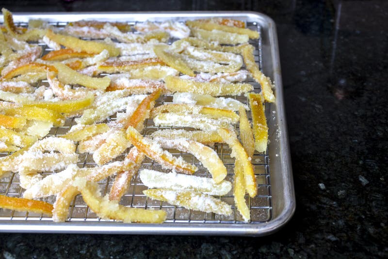 Candied orange and lemon peels resting in a pan to dry until done. Candied orange and lemon peels resting in a pan to dry until done