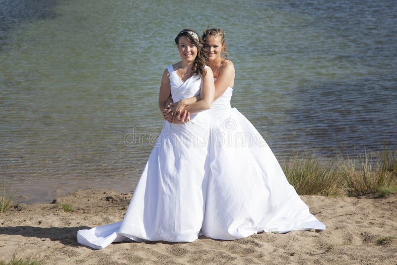 Just married happy lesbian couple in white dress embrace near sm stock photography Just married happy lesbian couple in white dress embrace near sm stock photography