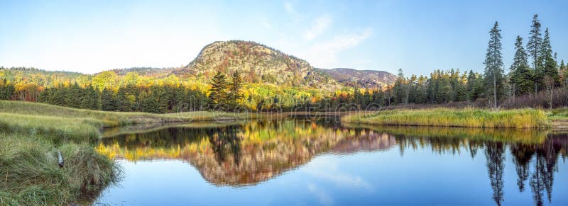 Just after sunrise, the Beehive, a summit on Mt. Desert Island, Maine, is surrounded with fall foliage color and displays a reflection on Beehive Lagoon near Sand Beach in Acadia National Park. Just after sunrise, the Beehive, a summit on Mt. Desert Island, Maine, is surrounded with fall foliage color and displays a reflection on Beehive Lagoon near Sand Beach in Acadia National Park