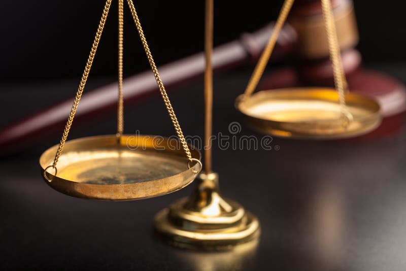 Justice Scales and wooden gavel on wooden table