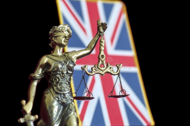 Justice夫人雕象有英国旗子的 免版税库存照片 Justice夫人雕象有英国旗子的 免版税库存照片