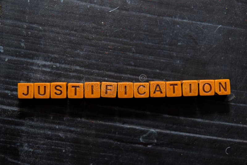 Justification on wooden cubes. On table background