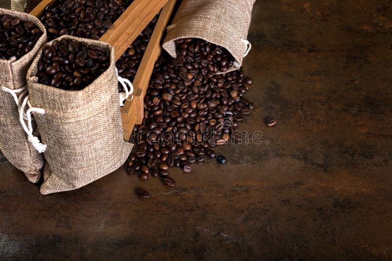 Jute Bags and Wooden Containers Filled with Cofee Beans Stock Photo