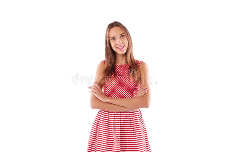 Juventude de sorriso atrativa com os braços dobrados que vestem o sta bonito do vestido foto de stock royalty free Juventude de sorriso atrativa com os braços dobrados que vestem o sta bonito do vestido foto de stock royalty free