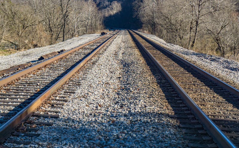 Pair of railroad tracks running through the mountains located in rural southwest Virginia, USA. Pair of railroad tracks running through the mountains located in rural southwest Virginia, USA.