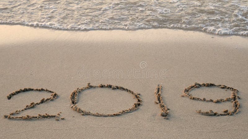 4K. happy new year 2019. year 2018 write on sandy beach, wave splash change to year 2019. countdown for happy new year