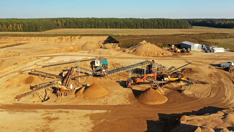 4K Sand quarry in working process with heavy machinery: sorting conveyor, bulldozers, excavators and trucks