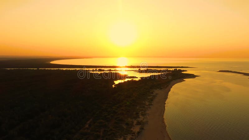 4K UHD Aerial drone view Beautiful sunset over tropical beach with clouds In the middle of the sea