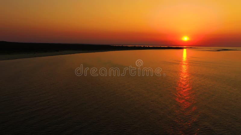 4K UHD Aerial drone view Beautiful sunset over tropical beach with clouds In the middle of the sea