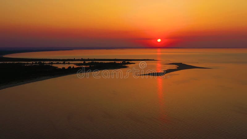 4K UHD Aerial drone view Beautiful sunset over tropical beach with clouds In the middle of the sea