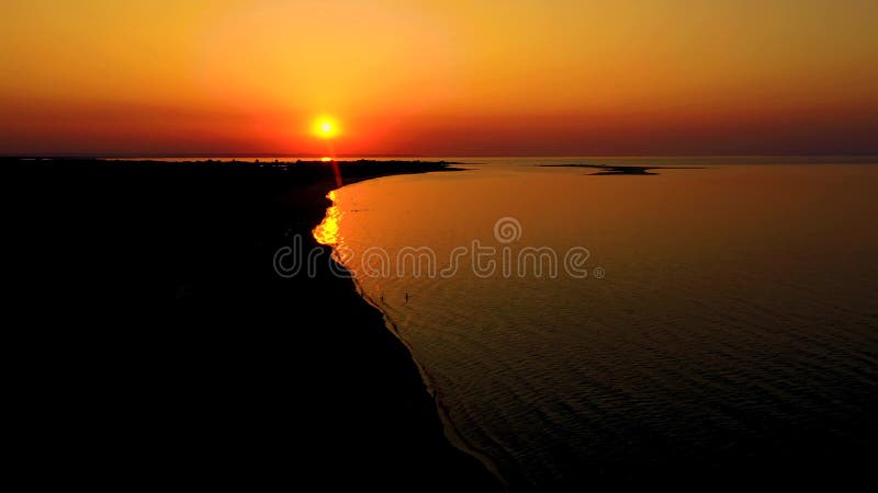 4K UHD Aerial drone view Beautiful sunset over tropical beach with clouds In the middle of the sea