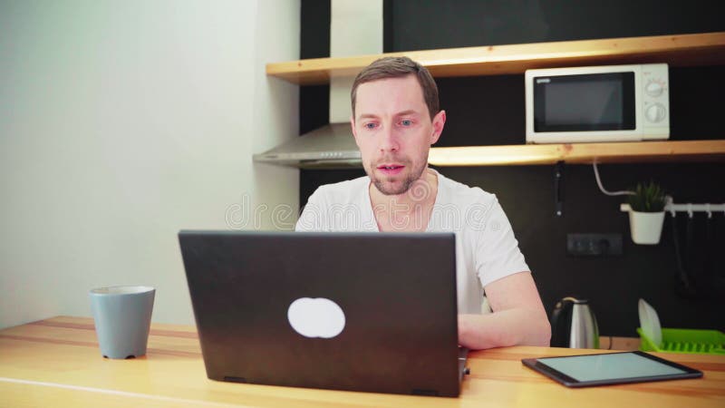 4K video. Young man using laptop. Guy hands typing at computer keyboard.