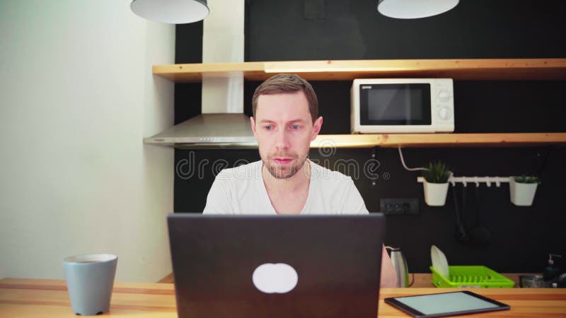 4K video. Young man using laptop. Guy hands typing at computer keyboard.