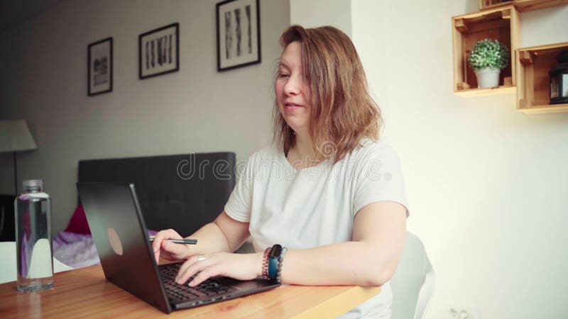 4K video. Young woman using laptop. Girl hands typing at computer keyboard
