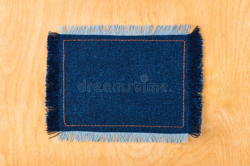 Kader voor de tekst van een jeansstof met de gestikte lijnen van een oranje draad en omzoomd stock afbeeldingen Kader voor de tekst van een jeansstof met de gestikte lijnen van een oranje draad en omzoomd stock afbeeldingen