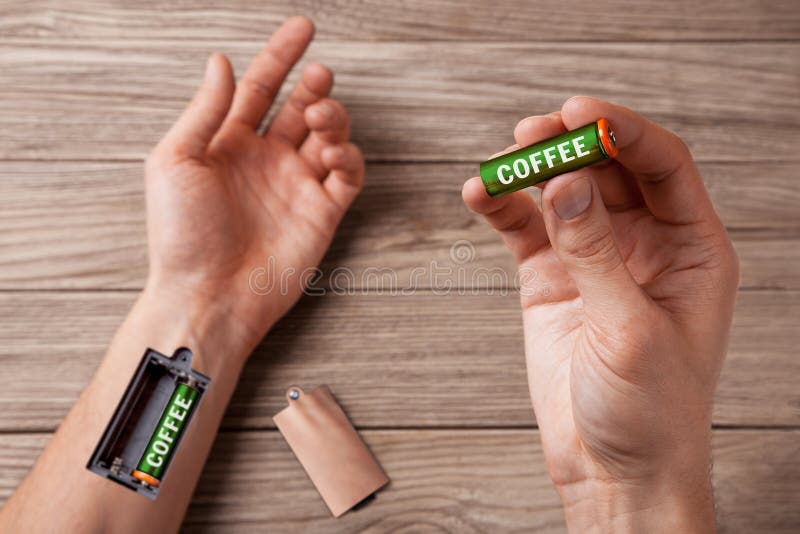 Coffee energizes. Hand of man with slot for charging batteries. Coffee energizes. Hand of man with slot for charging batteries.