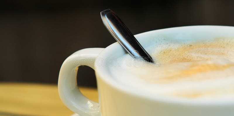 Panoramic of Cappuccino Coffee and spoon - Shallow DOF, focus on Foam. Panoramic of Cappuccino Coffee and spoon - Shallow DOF, focus on Foam