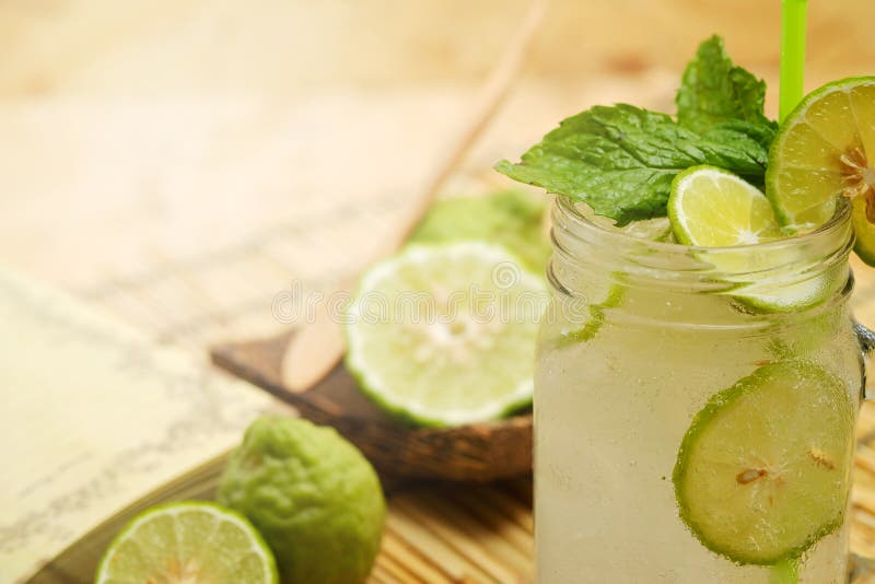 Kaffir lime So, Bergamot soda Cool drink, Thailand tradition Herb for Treatment of Acid Reflux, with Oriental Earth tone map backg. Round.Have some space for royalty free stock image Kaffir lime So, Bergamot soda Cool drink, Thailand tradition Herb for Treatment of Acid Reflux, with Oriental Earth tone map backg. Round.Have some space for royalty free stock image
