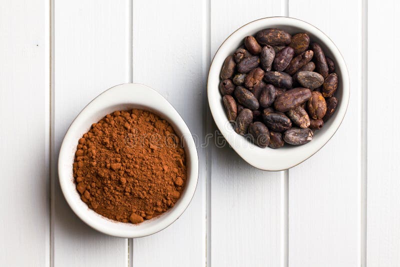 Top view of cocoa beans and cocoa powder in bowls. Top view of cocoa beans and cocoa powder in bowls