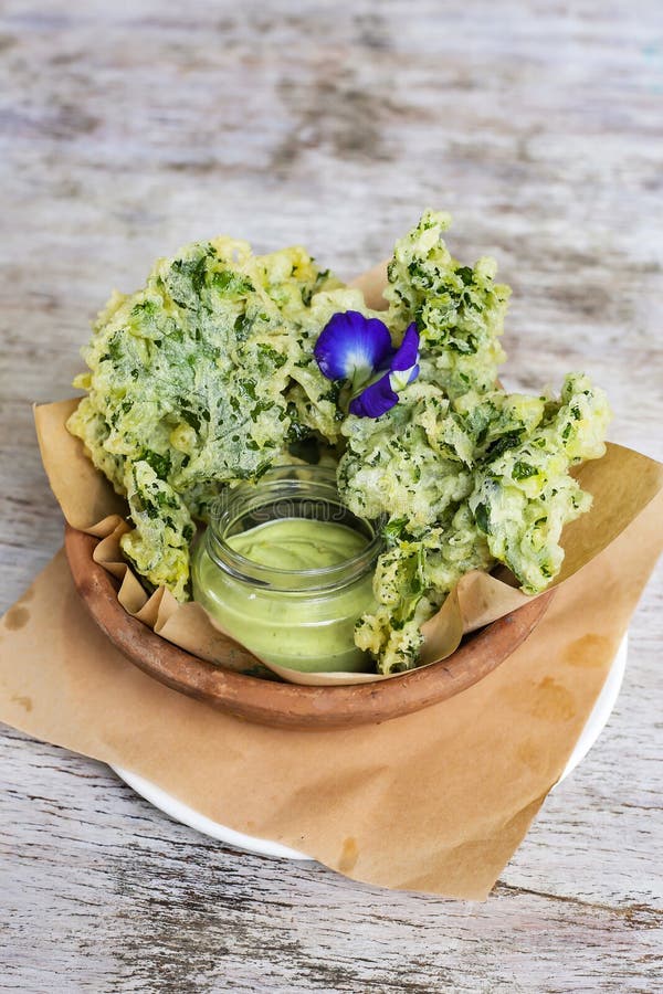 Kale Chips with Dip Served in a Dish Isolated on Grey Background Side