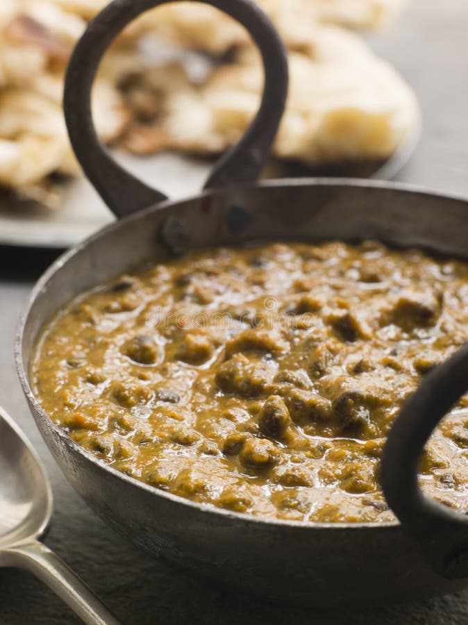 Close up of Kali Dahl Served in a Karahi With Naan Bread