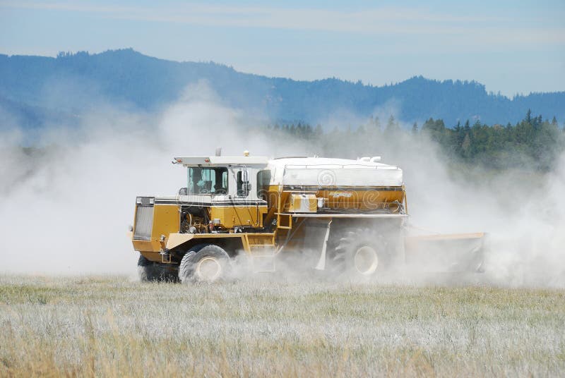 Agricultural lime being spread by a big wheeled truck in the Umpqua Valley near Roseburg Oregon. Agricultural lime being spread by a big wheeled truck in the Umpqua Valley near Roseburg Oregon