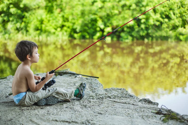 Calm child fisherman waiting for the catch. Calm child fisherman waiting for the catch