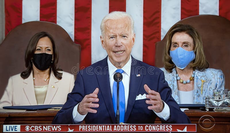 President Joe Biden gives an address to Congress coinciding with the marking of his 100 days as the Chief Executive.  He is flanked by Vice President Kamala Harris and Speaker of the House Nancy Pelosi who are wearing protective masks at the Capitol in Washington, DC on April 28, 2021.  The event was televised for this particular image by the CBS Television Network.  It was also televised live on all major American networks and on cable news  networks.  This was a signal event as it was the first time a United States President delivered essentially a State of the Union address in the presence of women holding these powerful and critical positions, Vice President, and Speaker of the House.  Due to the pandemic, the speech took place before a far smaller number of members of both Houses of Congress and only one Supreme Court Justice. President Joe Biden gives an address to Congress coinciding with the marking of his 100 days as the Chief Executive.  He is flanked by Vice President Kamala Harris and Speaker of the House Nancy Pelosi who are wearing protective masks at the Capitol in Washington, DC on April 28, 2021.  The event was televised for this particular image by the CBS Television Network.  It was also televised live on all major American networks and on cable news  networks.  This was a signal event as it was the first time a United States President delivered essentially a State of the Union address in the presence of women holding these powerful and critical positions, Vice President, and Speaker of the House.  Due to the pandemic, the speech took place before a far smaller number of members of both Houses of Congress and only one Supreme Court Justice.