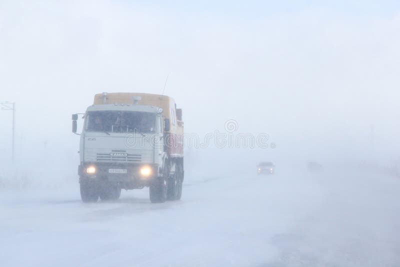 Novyy Urengoy, Russia - May 2, 2015: Offroad truck Kamaz 43114 at an interurban road during a heavy snowstorm