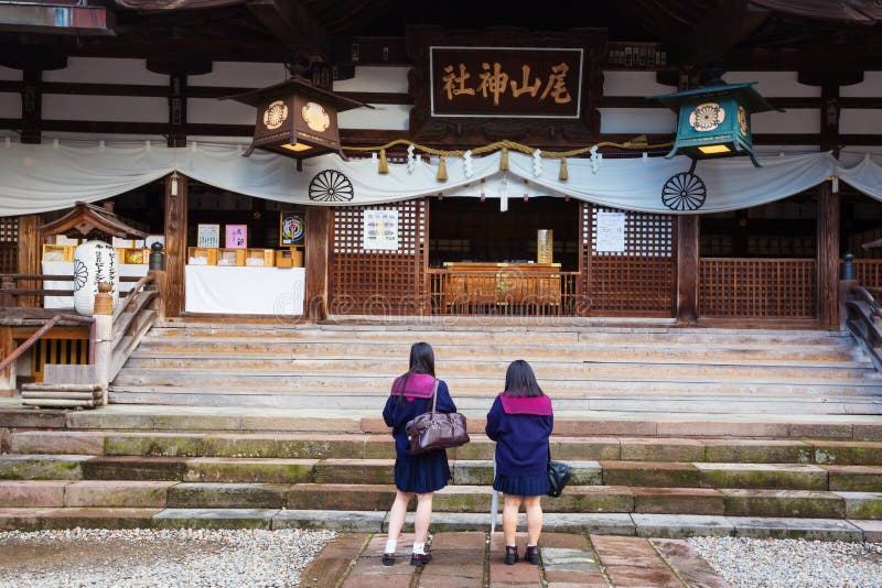 Two japanese schoolgirls pray at Oyama Jinja Shrine. Kanazawa, Japan stock images Two japanese schoolgirls pray at Oyama Jinja Shrine. Kanazawa, Japan stock images