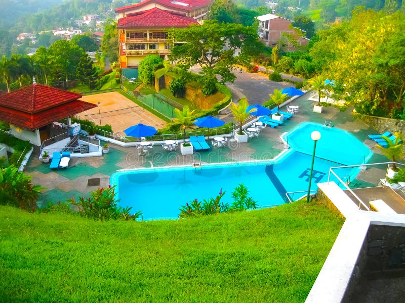 Kandy, Sri Lanka - May 02, 2009: Swimming pool of hotel Hotel Topaz 3 stars at Kandy, Sri Lanka on May 02, 2009. Kandy, Sri Lanka - May 02, 2009: Swimming pool of hotel Hotel Topaz 3 stars at Kandy, Sri Lanka on May 02, 2009