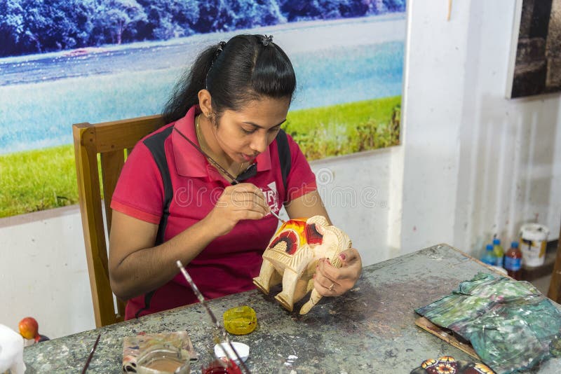 Kandy, Sri Lanka: 03/18/2019: Skilled wood carver hand crafting carvings for the tourist souvenirs