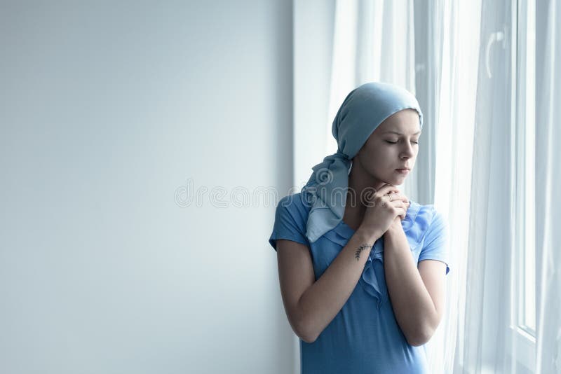 Cancer survivor deep in thought standing by the window. Cancer survivor deep in thought standing by the window