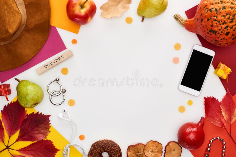Hat, smartphone, fruits, pumpkin, dry leaves, multicolored papers, donut, coffee grains, wooden block with october inscription isolated on white,stock image. Hat, smartphone, fruits, pumpkin, dry leaves, multicolored papers, donut, coffee grains, wooden block with october inscription isolated on white,stock image