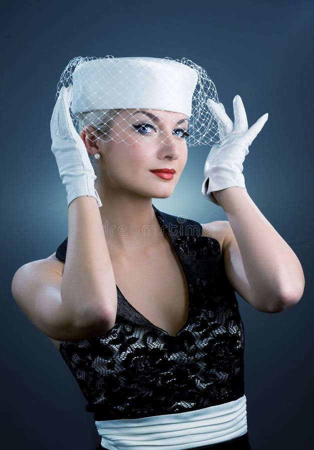 Beautiful young woman in white hat with net veil. Retro portrait. Beautiful young woman in white hat with net veil. Retro portrait