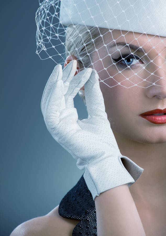 Beautiful young woman in white hat with net veil. Retro portrait. Beautiful young woman in white hat with net veil. Retro portrait