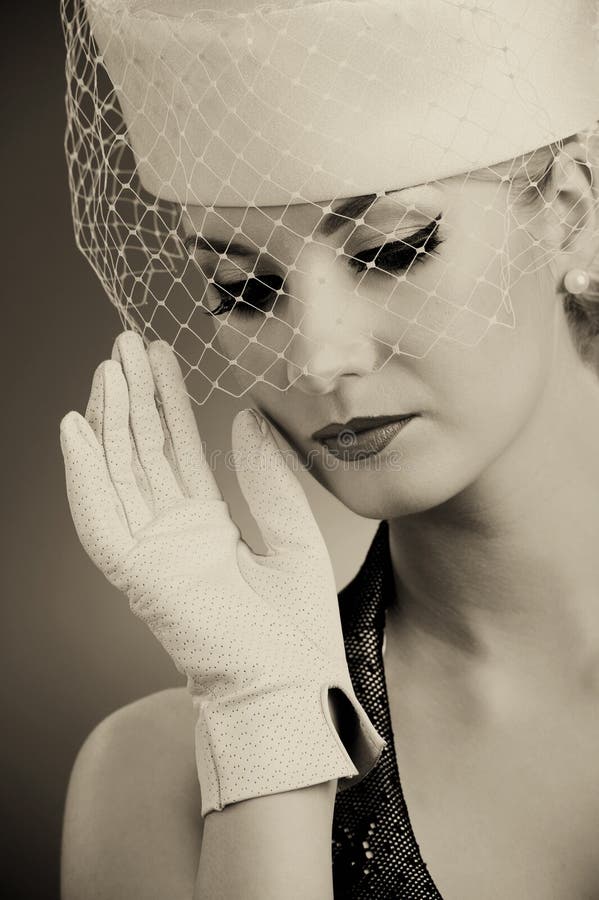 Beautiful young woman in hat with net veil. Retro portrait. Beautiful young woman in hat with net veil. Retro portrait