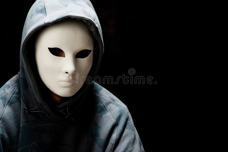 Man wearing white mask and hood, studio shot. Man wearing white mask and hood, studio shot