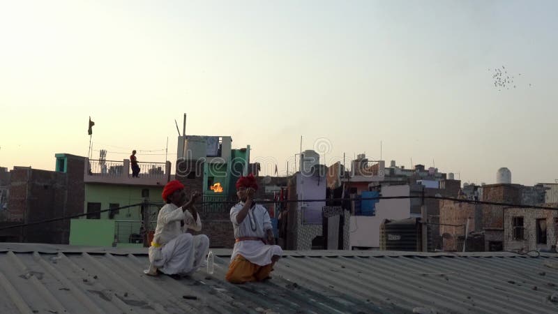 Kaputhli, India - 20180227 - Two Fire Breathers On Rooftop Show Their Skill.