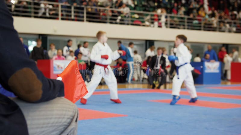 Karate de las competencias del arte marcial - juzgue a los coches que miran la lucha femenina del karate del ` s del adolescente foto de archivo Karate de las competencias del arte marcial - juzgue a los coches que miran la lucha femenina del karate del ` s del adolescente foto de archivo