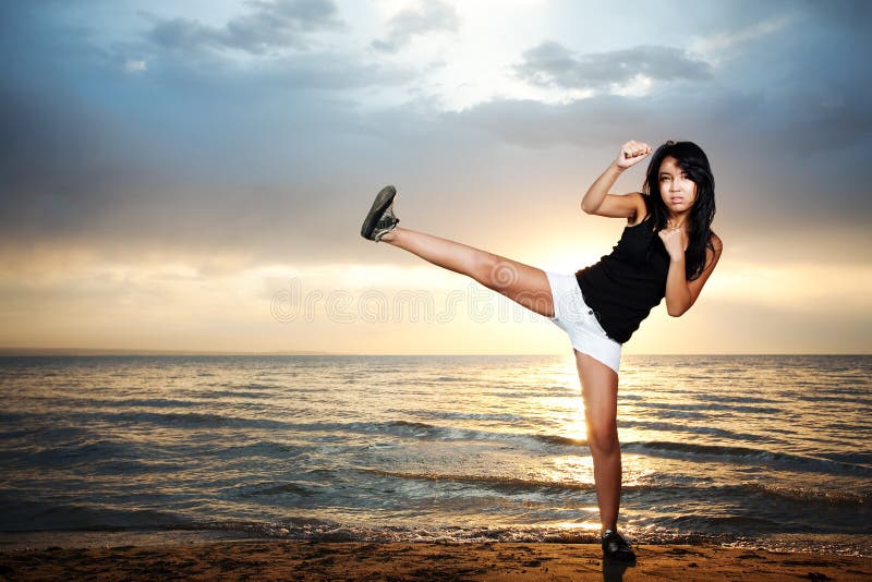 Karate girl on the beach