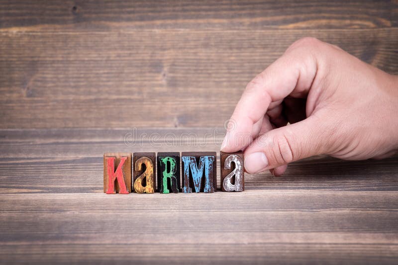 Karma. Wooden letters on the office desk