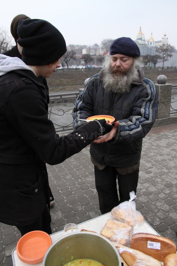 KHARKIV, UKRAINE - MARCH 13, 2016: Some anarchist activists and anarcha-feminists adherents held next FNB Food No Bombs campaign feeding the homeless in Kharkiv. KHARKIV, UKRAINE - MARCH 13, 2016: Some anarchist activists and anarcha-feminists adherents held next FNB Food No Bombs campaign feeding the homeless in Kharkiv.