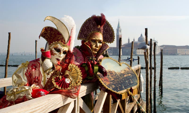 Pair from venice carnival and lagoon with the san giorgio chruch in background. Pair from venice carnival and lagoon with the san giorgio chruch in background