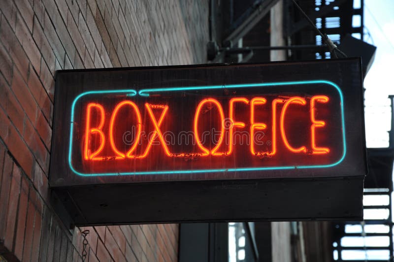 Box office neon sign posted along the building wall. Box office neon sign posted along the building wall