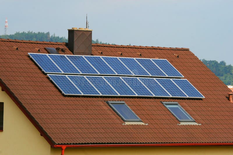 Some solar panels on red home roof. Some solar panels on red home roof