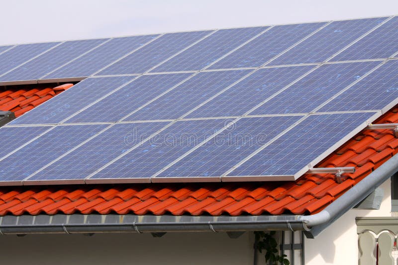 Some solar panels on red home roof. Some solar panels on red home roof.