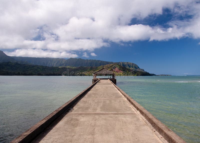 View down the pier at Hanalei in Kauai towards the Na Pali coast. View down the pier at Hanalei in Kauai towards the Na Pali coast