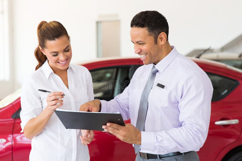 Happy women buying a new car at vehicle showroom. Happy women buying a new car at vehicle showroom