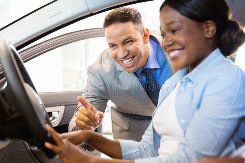 Beautiful african american women buying a car at dealership. Beautiful african american women buying a car at dealership